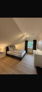 a large bedroom with a bed and a window at Skywalk Loft Willingen in Willingen