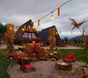 a backyard with chairs and a house with lights at Krushevski Konaci 2 in Kruševo +22 photos