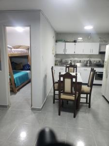 a kitchen and dining room with a table and chairs at Casa hotel la 33 in Medellín