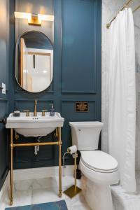 a bathroom with a toilet and a sink and a mirror at Brooklyn Brownstone in Brooklyn