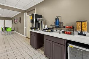 a kitchen with a counter and a table and chairs at Americas Best Value Inn - Wilson in Wilson