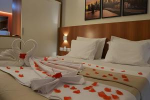 two beds in a hotel room with hearts on them at Pipa's bay - Praia do Amor in Pipa +41 photos