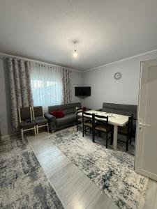 a living room with a couch and a table at Bujtina e Kadrise in Kukës