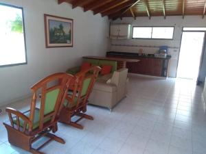 a living room with two chairs and a couch at CABAÑA LOS JARDINES -Playa Mendoza in Tubará