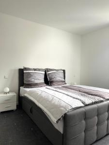 a large bed in a bedroom with a white wall at Apartment in Rittersdorf in Rittersdorf