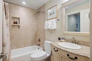 a bathroom with a sink and a toilet and a tub at WS5123: 5123 Windswept in Kiawah Island +33 photos
