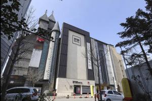 a building with a clock on the side of it at 12번길stay 