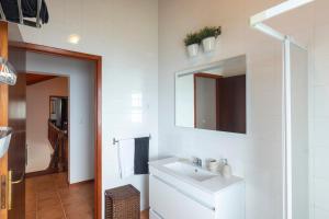 a white bathroom with a sink and a mirror at Casa da Vigia, Seaview House - sleeps 8 people in Feteira Grande +57 photos