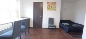 a room with a bed and a table and chairs at БіднийЗаяць in Lebedevka +2 photos