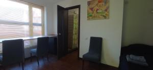 a room with two chairs and a door with a window at БіднийЗаяць in Lebedevka