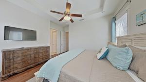 a bedroom with a bed and a ceiling fan at Prominence 30A - Mint Julep in Inlet Beach