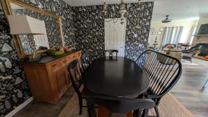 a dining room with a black table and chairs at Spacious Entire home close to HoliMont and Village in Ellicottville