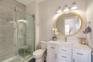 a bathroom with a toilet and a shower and a mirror at Gig Harbor House with Private Beach and Views! in Gig Harbor +30 photos