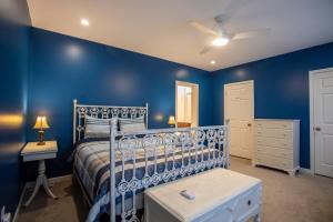 a bedroom with blue walls and a bed and a nightstand at Spacious Entire home close to HoliMont and Village in Ellicottville
