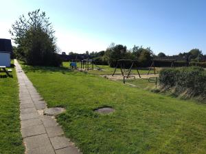 a park with an empty playground with at Delightful townhouse in Ikast in Ikast +1 photo