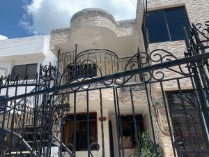 a house with a wrought iron fence at La casa de Fefa in Ríohacha
