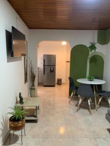 a room with a table and chairs and a refrigerator at La casa de Fefa in Ríohacha +9 photos