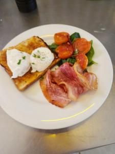 a white plate of food with eggs and toast at The Garden Flat in Mangonui