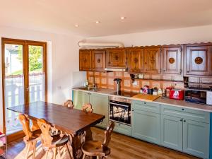 a kitchen with wooden cabinets and a wooden table at Alpine Vista Villa Hardaker 4 bedrooms Torgnon in Torgnon