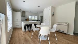 a kitchen with a table and chairs in a room at 34 Jacks Pass Road in Hanmer Springs +7 photos