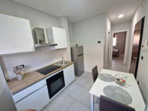 a kitchen with a table and a counter top at Casa Alba Napoli in Naples
