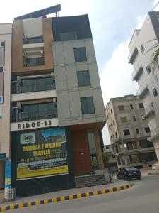 a building with a sign on the side of it at Luxury Stay at 2 Bedroom Apartment in Citi Housing Jhelum in Jhelum