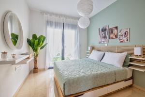 a bedroom with a bed and a large window at Anna Maria Suite in Rhodes Town