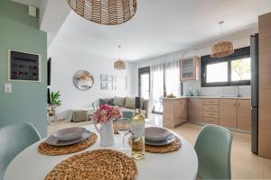 a kitchen and dining room with a table and chairs at Anna Maria Suite in Rhodes Town