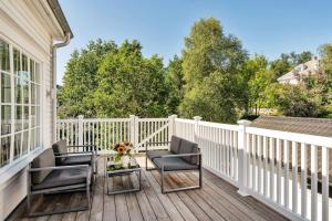a porch with two chairs and a table on a white fence at Arctic hilltop lodge - Room 1 in Guleng