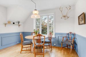a dining room with a table and chairs at Arctic hilltop lodge - Room 1 in Guleng