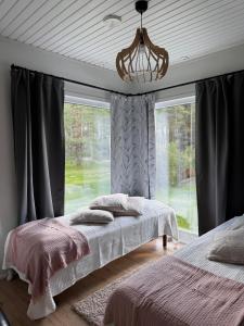 una camera con due letti davanti a una finestra di Villa Ketola a Ranua Altre 32 foto