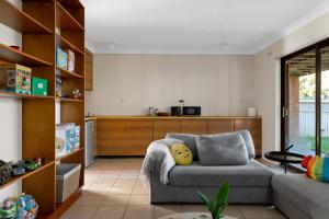 a living room with a couch and a kitchen at San Remo Charm with Waterfront Views and Sunroom in Blue Haven
