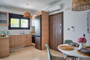 a kitchen and dining room with a table and chairs at Anna Maria Suite in Rhodes Town +29 photos