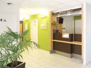 a waiting room at a hospital with a potted plant at B&B HOTEL Marseille Aéroport Saint-Victoret in Saint-Victoret