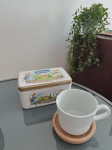 a table with two containers and a cup on it at Mikołowska 9 pokój in Gliwice