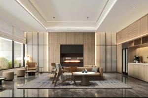 a living room with a couch and a fireplace at Fairfield by Marriott Shanghai Xuhui Center in Shanghai
