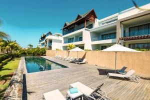 a resort with a swimming pool and lounge chairs at Mythic Suites & Villas by MJ Holidays in Grand Gaube