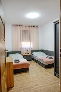 a room with two beds and a window at Ada Lake & Family Suite in Sława