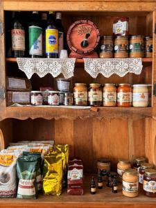 a shelf filled with lots of different types of food at Hotel Izaura Centro Comercial Juruaia in Juruaia