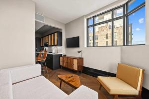 a living room with a couch and a desk at Freeman II by Rove 1BR Condo with Shared Amenities in New York