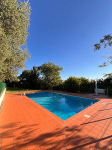 a swimming pool sitting on a red tiled floor at Casa Jeyel in Lazise