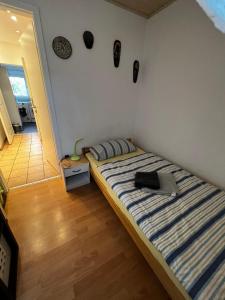 a bedroom with a bed with a laptop on it at Zentrales Apartment in Würzburg-Heidingsfeld in Würzburg