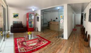 a living room with a couch and a red rug at Hotel Raiz in Manaus