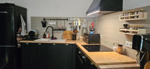 a kitchen with green cabinets and a counter top at Bairro Novo - Alojamento Local in Figueira da Foz +155 photos