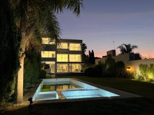a house with a swimming pool in front of a building at Ríohaus in Pueblo Esther