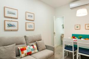 a living room with a couch and a table at Hotel Apartamento Bajamar in Las Palmas de Gran Canaria