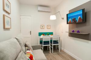 a living room with a couch and a table at Hotel Apartamento Bajamar in Las Palmas de Gran Canaria