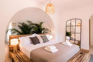 a bedroom with a bed with two towels on it at Can Vishnu in San Jose +36 photos