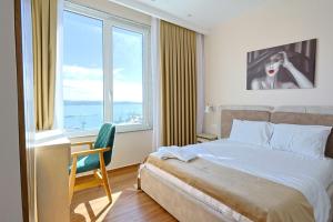 a bedroom with a bed and a desk and a window at Lux Holidays 221 in Durrës