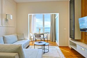 a living room with a couch and a table at Lux Holidays 221 in Durrës